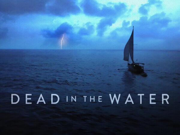 a sailboat in the water with a lightning bolt in the background and the text Dead in the Water underneath